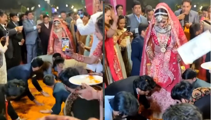 سوشل میڈیا پر ایک ویڈیو وائرل ہورہی ہے جس میں بظاہر دلہن کے بھائی اپنی بہن کی شادی کے موقع پر ہونے والی انٹری پر اپنی ہتھیلیاں بہن کے قدموں تلے رکھ رہے ہیں —فوٹو: اسکرین گریب