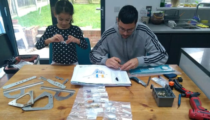 Ashok working with his daughter on building the plane / Photo courtesy of CNN