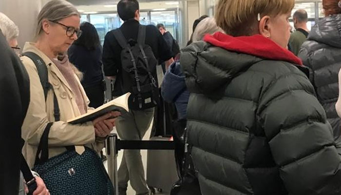 واشنگٹن ائیرپورٹ پربھی امیگریشن  کی لمبی قطاروں میں کھڑے کئی افراد کتابیں پڑھ کر وقت کا بہتر استعمال کرتے رہے— فوٹو: جیو نیوز